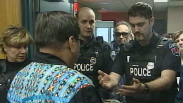 Police officers take part in a native ceremony; Hamilton, March 20, 2014