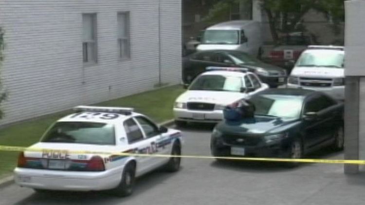 Police at Geneva St apartment building where shots were reported in a parking garage; St Catharines, June 5, 2014