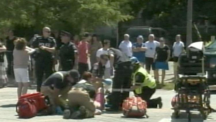 Paramedics look after a girl hit by a pick-up truck; St Catharines, July 24, 2014