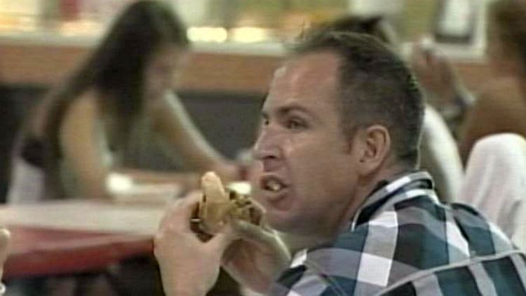 Man eating food at CNE midway; 2013