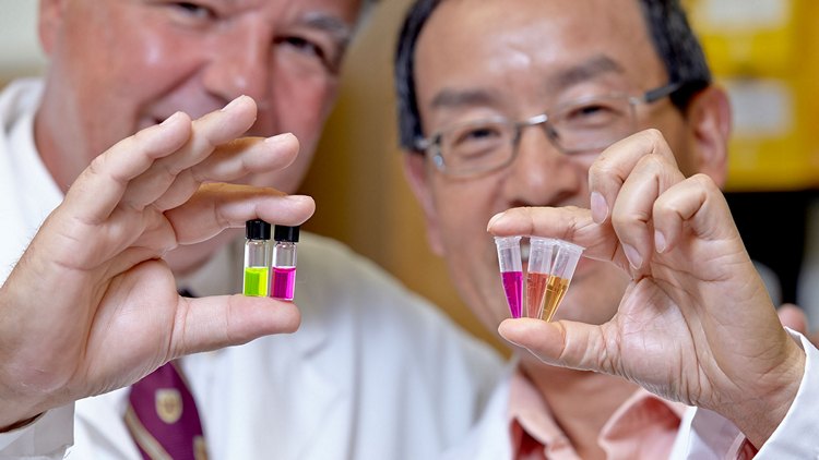 Researchers hold vials of experimental colon cancer tests (Canadian Cancer Society/CNW Group)