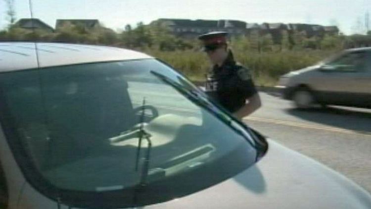 A Niagara Regional Police officer talks to a driver; Niagara-on-the-Lake, September 17, 2014