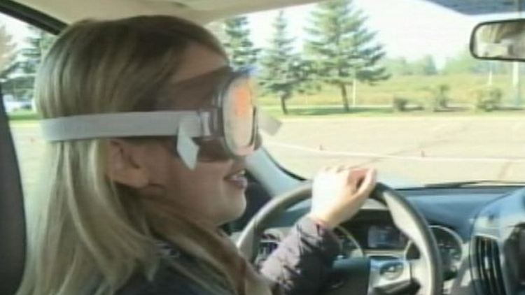 Nicole Martin wears a pair of goggles to simulate distracted driving; Brampton, September 24, 2014