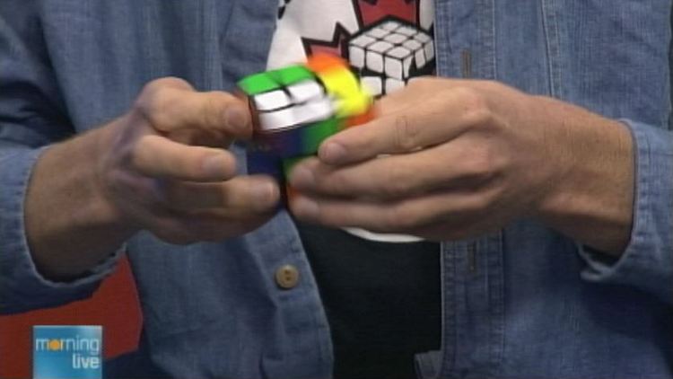 Champion cuber Thompson Clark works a Rubik's Cube; Morning Live, September 29, 2014