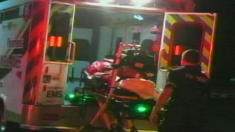 A woman is loaded into an ambulance to be treated for smoke inhalation; Niagara Falls, October 8, 2014