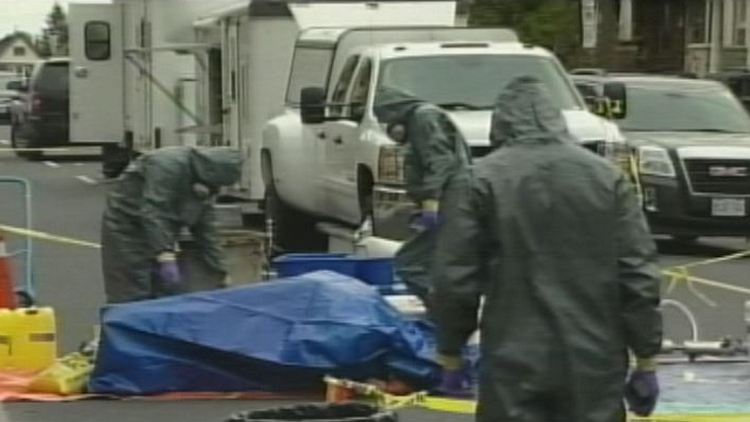 Forensics officers stage chemicals used in a Hamilton drug factory; November 12, 2014