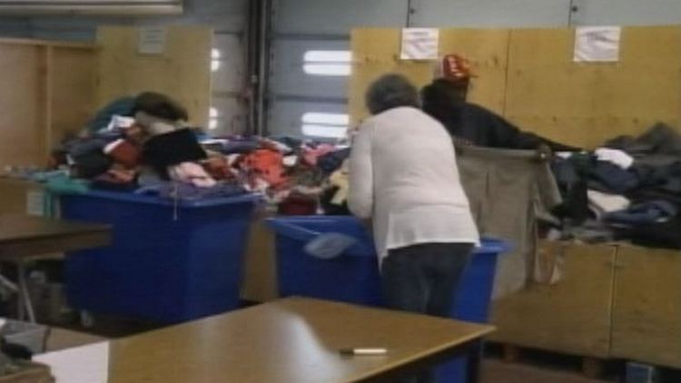 Volunteers sort through clothing donations at the Good Shepherd Centre, Hamilton, November 18, 2014