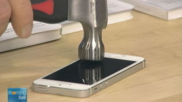 A hammer hits an iPhone covered with Phantom Glass; Morning Live, December 11, 2014