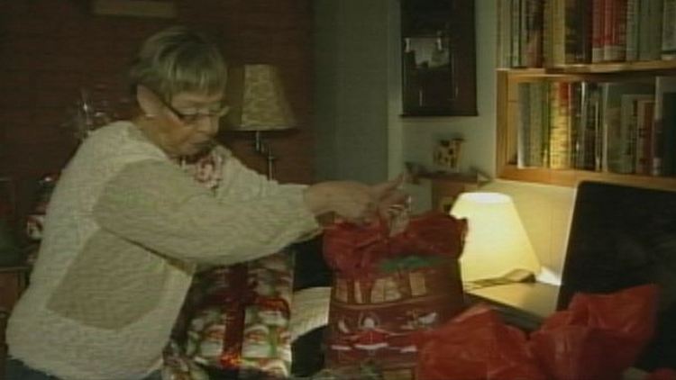 Lyn Roberts arranging gift donations in her home; Hamilton, December 22, 2014