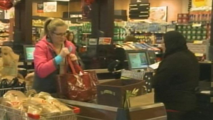 A shopper being checked out at Longo's Fairview; Burlington, December 23, 2014