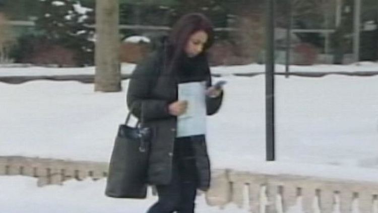 A terminated Tim Hortons employee checks her smartphone; Oakville, January 27, 2015