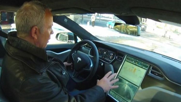 Bob Cowan behind the wheel of the Tesla Model S; Morning Live, aired March 6, 2015