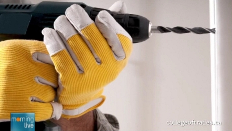 Archive image of a carpenter drilling a wall