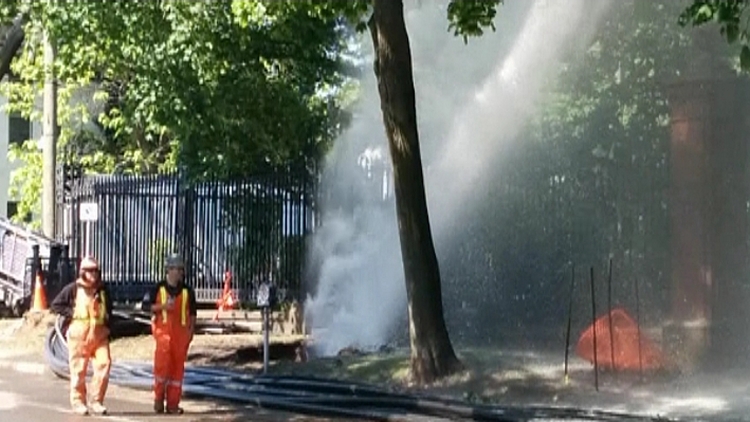 Water gushing from a burst main outside the Scottish Rite; Hamilton, June 2, 2015