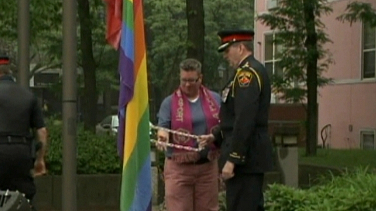Deirdre Pike & Hamilton Police Chief Glenn De Caire raising the Pride flag; June 15, 2015
