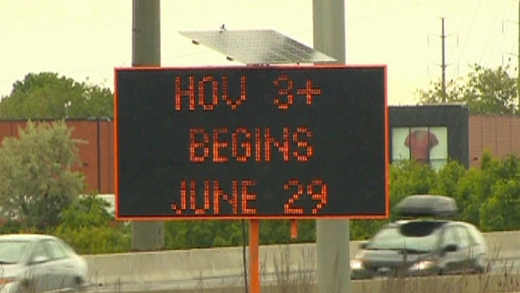 Road sign showing HOV lanes 3+ rule begin June 29