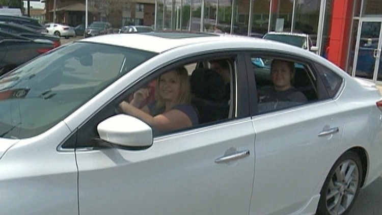 CH-CHing! winner Jennifer Witlox drives away her prize, a Nissan Sentra SR Premium; Hamilton, June 29, 2015