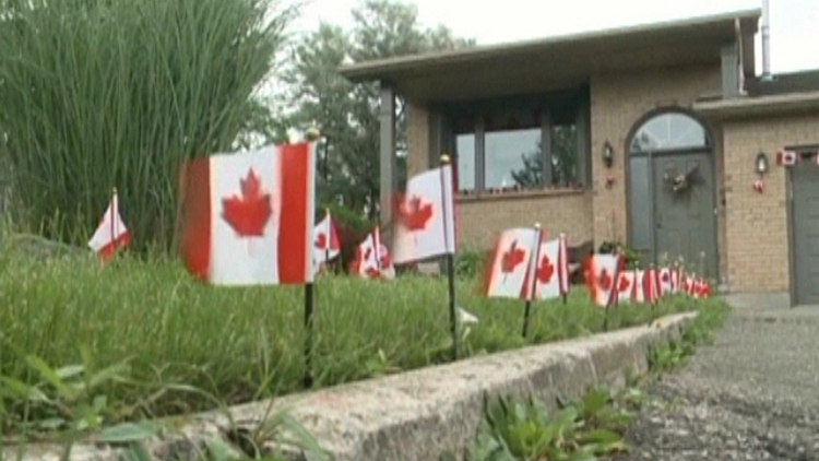 Canadian flags posted along a driveway