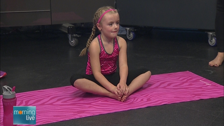 A child performing yoga on Morning Live, September 28, 2015