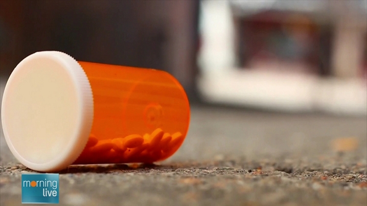 A prescription bottle on its side on a kitchen counter