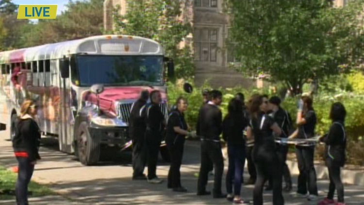 McMaster University students pull a bus to raise funds for the United Way; Hamilton, October 1, 2015