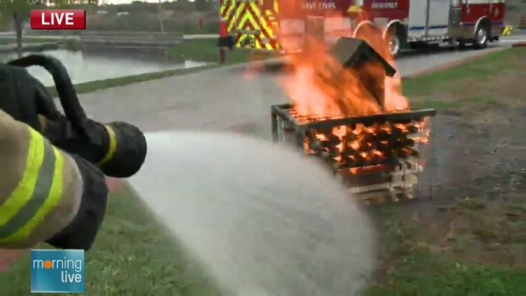 A firefighter puts out a blaze set as a demonstration; Morning Live, October 7, 2015