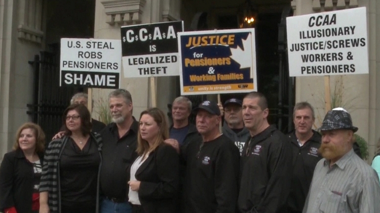 Steelworkers local 8782 president Bill Ferguson flanked by supporters outside the court where the U.S. Steel Canada CCAA motion is being heard; Toronto, October 7, 2015