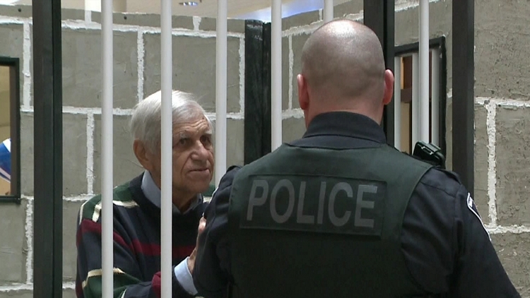 CHCH director Nick Olchowy behind bars at Crime Stoppers of Halton fundraiser; Burlington, October 17, 2015