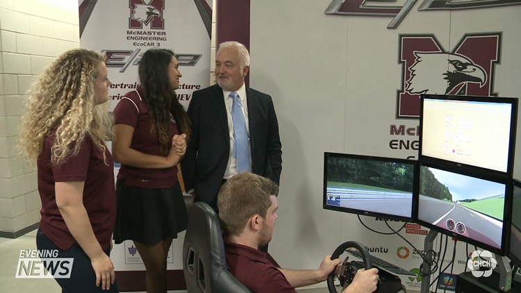 GM Canada president Steve Carlisle (centre) talks to McMaster engineering students; Hamilton, October 29, 2015