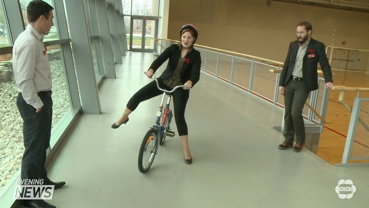 CHCH's Elise Copps (centre) tries a backwards bicycle at Brock University; St Catharines, November 10, 2015