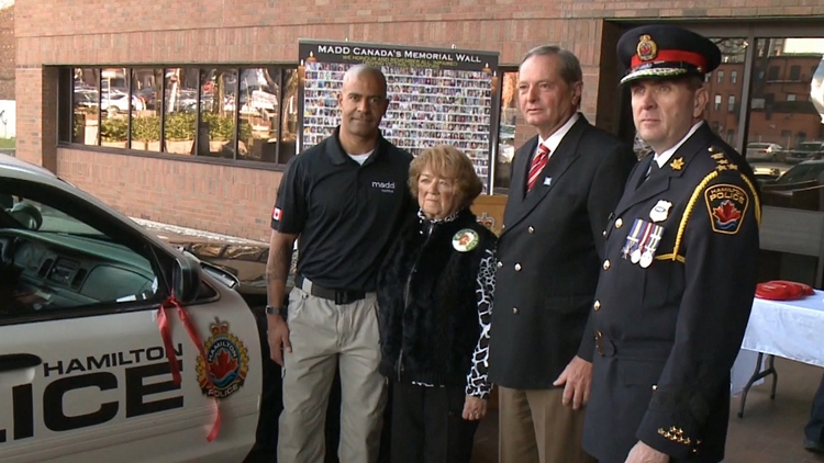 Florence Holzel, flanked to her left by Lloyd Ferguson and Hamilton Police Chief Glenn De Caire; November 17, 2015