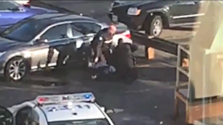 Frame grab from a YouTube video of Toronto Police allegedly assaulting a suspect