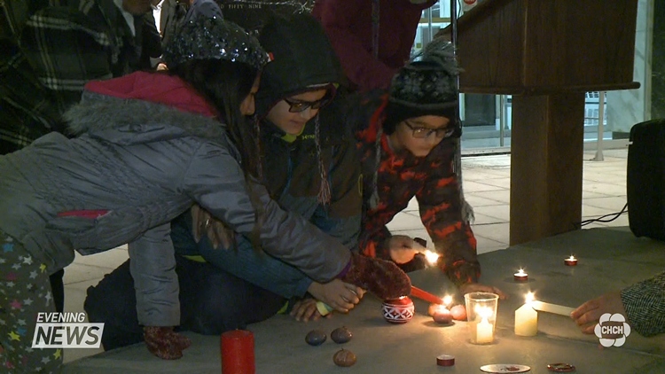 Children lighting candles at a rally at Hamilton City Hall, November 19, 2015