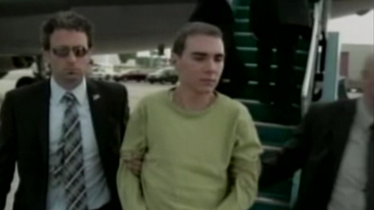 Luka Magnotta being escorted off a plane