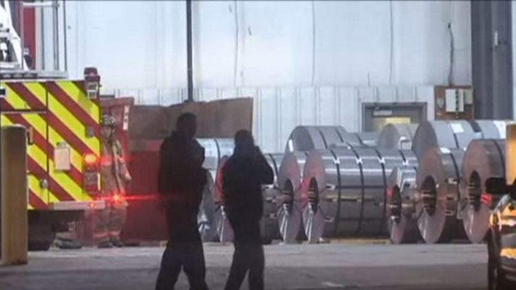 Emergency responders working near coils of steel at Samuel Metal Processing