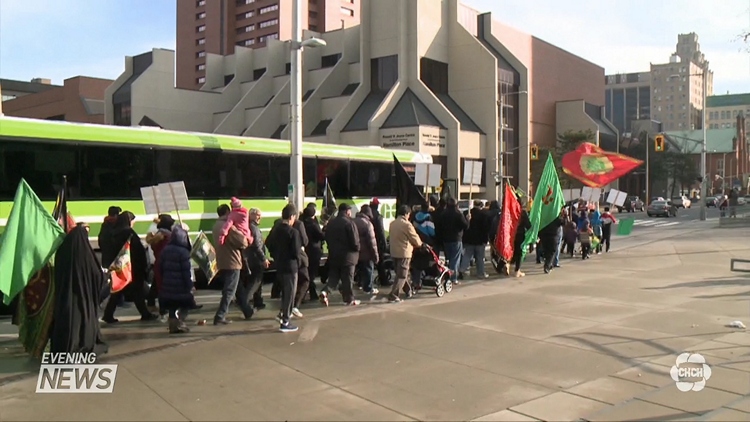 Members of the Al-Mustafa Islamic Centre gather in front of Hamilton City Hall, December 2, 2015