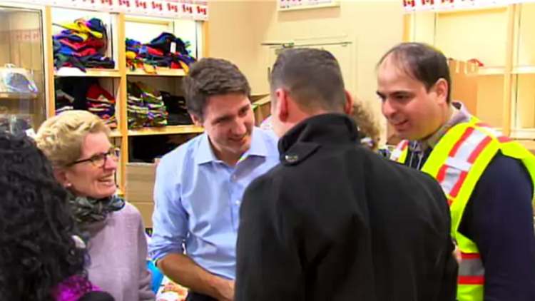 Justin Trudeau & Kathleen Wynne greet refugees at Pearson