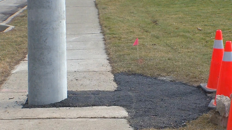 Hydro pole on sidewalk