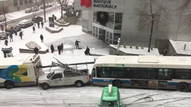 Two buses, police cruiser, cars all slide down Montreal hill