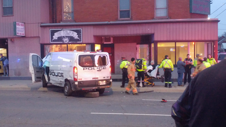 Driver on cell phone smashes into Hamilton police van