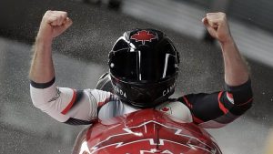 Driver Justin Kripps and Alexander Kopacz of Canada celebrate as they cross the finish area after tying for the gold with Germany during the two-man bobsled final at the 2018 Winter Olympics in Pyeongchang, South Korea, Monday, Feb. 19, 2018. (AP Photo/Michael Sohn)