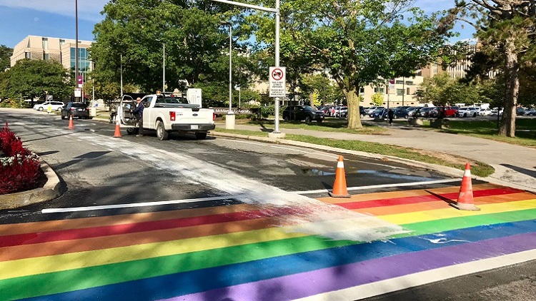 Rainbow crosswalk at McMaster splattered with white paint