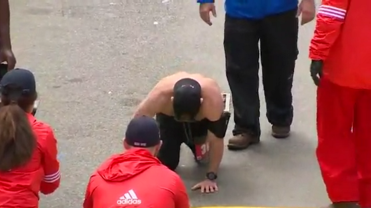 Marine crawls across Boston Marathon finish line