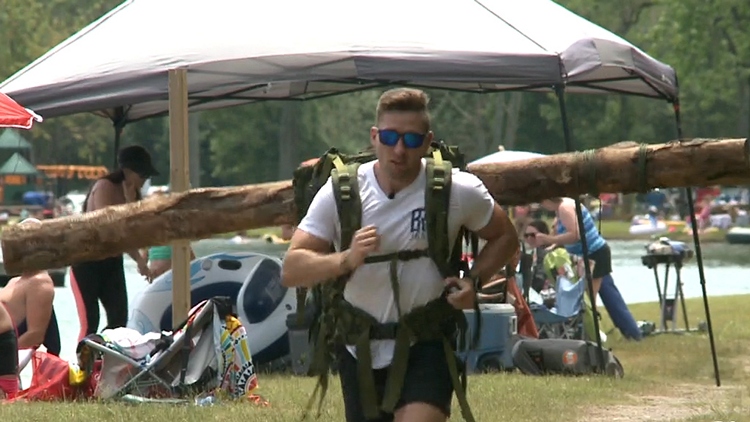 A Burlington man gears up to compete in a triathlon with a tree strapped to his back