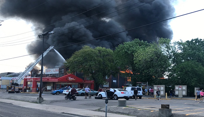 Hamilton fire crews battle large fire at Mr. Used building