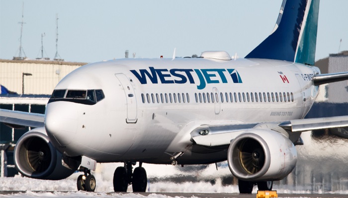 WestJet cutting flights, laying off more staff