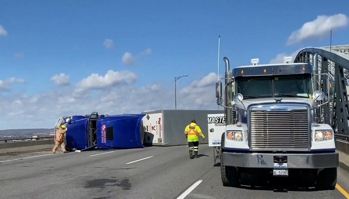 Transport truck tipped over on the Burlington Skyway bridge due to high winds