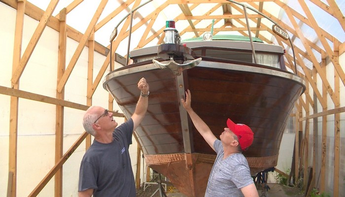 A refugee family from Ukraine helps to restore a boat almost five decades old