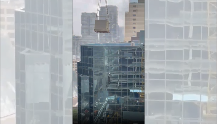 Stunning video shows Toronto construction worker hanging from crane