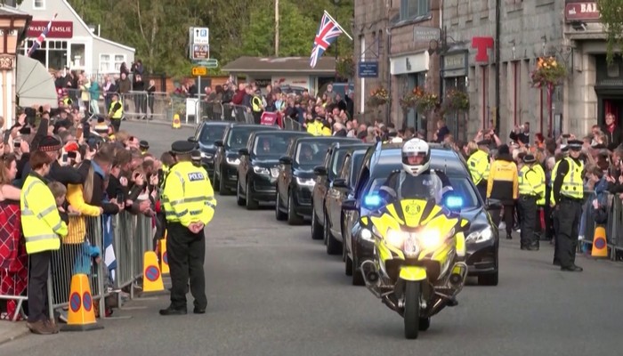 People throughout England and Scotland paid emotional tributes to the Queen Sunday as her coffin began a week-long journey to Edinburgh and London for her funeral